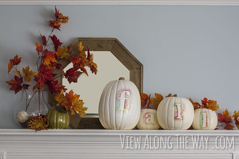 Fall mantle decorated with watercolor pumpkins and fall leaves