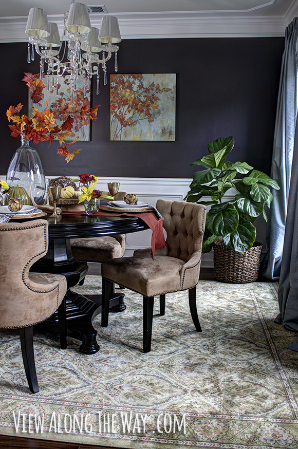 Dining room decorated for fall with autumn-inspired centerpiece
