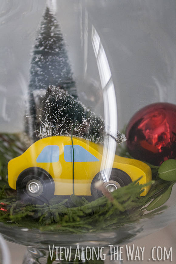 Toy car carrying a christmas tree