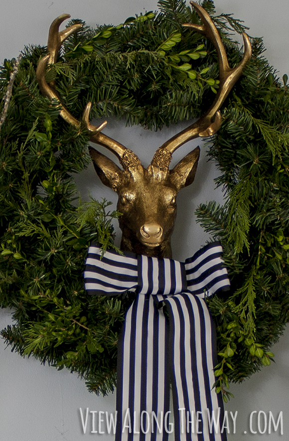 Brass deer with wreath and bowtie
