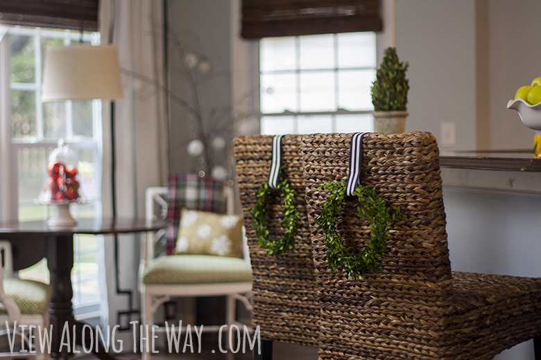 Hang little DIY wreaths from the back of a barstool for a cheap, easy Christmas decoration!
