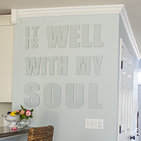 Use a laser level to hang canvas letters