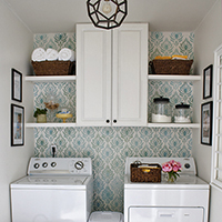 DIY laundry room with painted shelves and cabinet