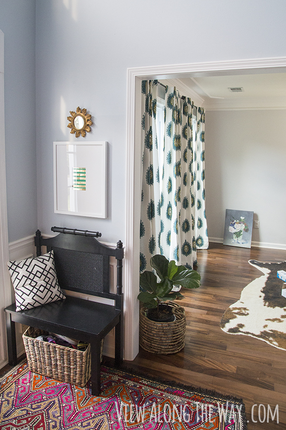 Patterned curtains and a colorful rug